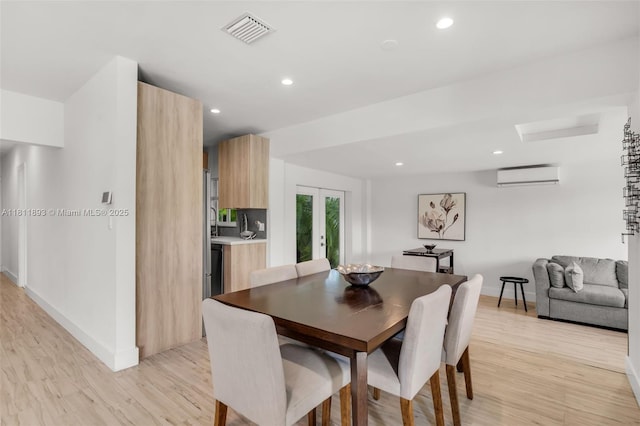 17491 NE 19th Ave, North Miami Beach, FL 33162 - dining room featuring a wall mounted AC, baseboards, light wood-style flooring, recessed lighting, and french doors