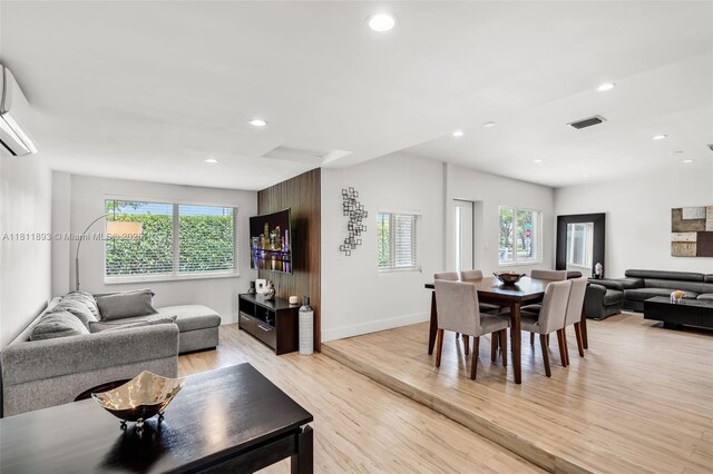 17491 NE 19th Ave, North Miami Beach, FL 33162 - living room with light wood-style floors, recessed lighting, a wall mounted AC, and baseboards