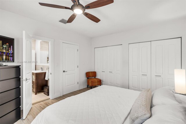 17491 NE 19th Ave, North Miami Beach, FL 33162 - bedroom with multiple closets, light wood finished floors, ensuite bathroom, ceiling fan, and baseboards
