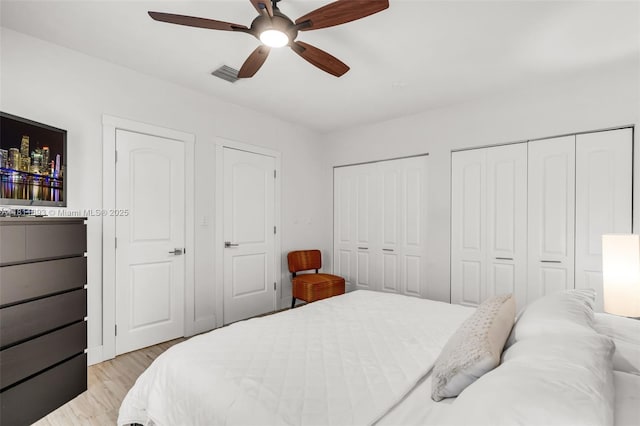 17491 NE 19th Ave, North Miami Beach, FL 33162 - bedroom with multiple closets, light wood-style floors, and a ceiling fan