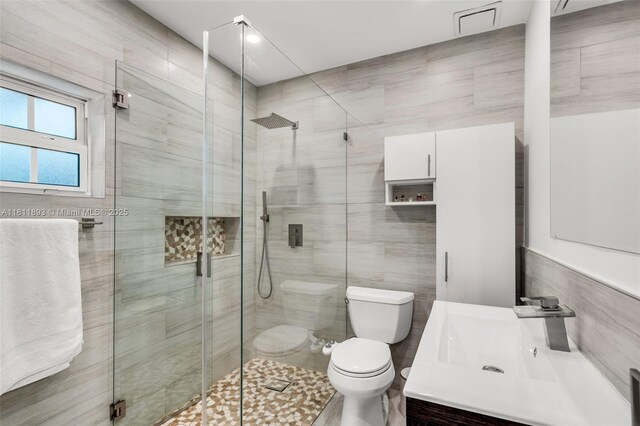 17491 NE 19th Ave, North Miami Beach, FL 33162 - bathroom featuring toilet, tile walls, a shower stall, and vanity