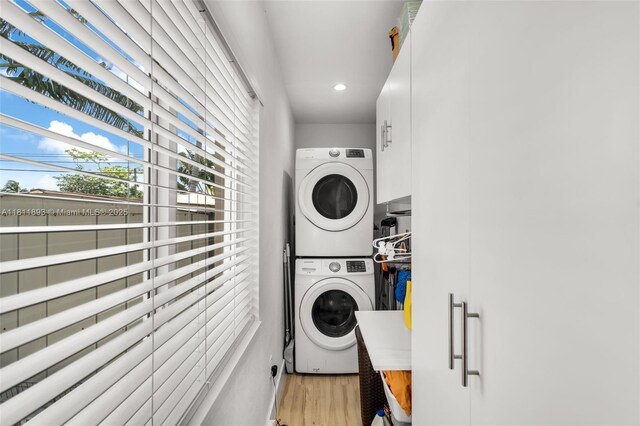 17491 NE 19th Ave, North Miami Beach, FL 33162 - washroom featuring stacked washer and clothes dryer, light wood-style floors, and recessed lighting