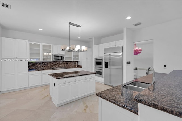 19347 SW 79th Pl, Cutler Bay, FL 33157 - kitchen with stainless steel appliances, a sink, a center island, glass insert cabinets, and a chandelier