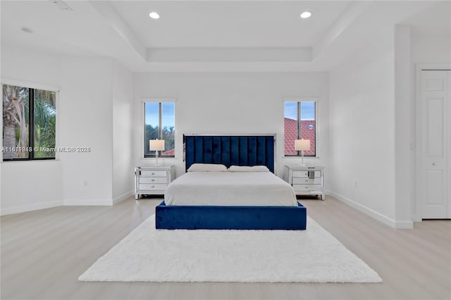 19347 SW 79th Pl, Cutler Bay, FL 33157 - bedroom featuring light wood-style floors, a tray ceiling, baseboards, and recessed lighting
