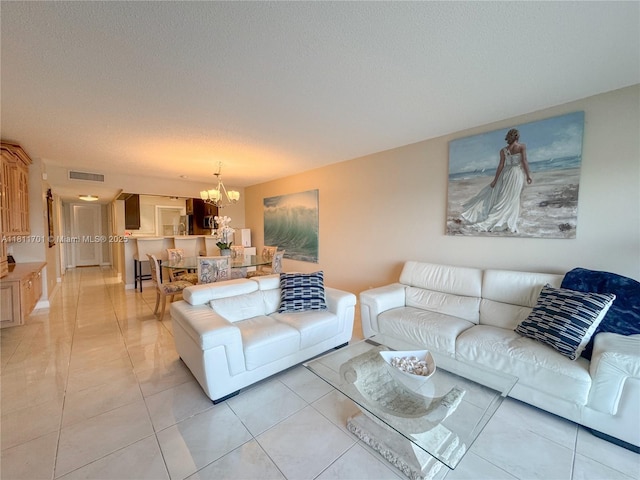 2097 S Ocean Dr Unit 302, Hallandale Beach, FL 33009 - living room featuring a chandelier, light tile patterned floors, and a textured ceiling
