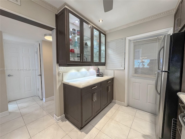 2097 S Ocean Dr Unit 302, Hallandale Beach, FL 33009 - bar with freestanding refrigerator, baseboards, light tile patterned flooring, and crown molding