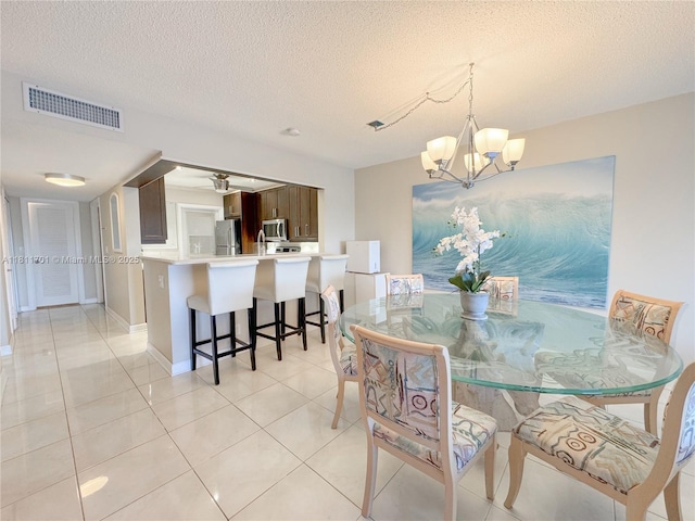 2097 S Ocean Dr Unit 302, Hallandale Beach, FL 33009 - dining room featuring a chandelier, a textured ceiling, light tile patterned floors, and baseboards