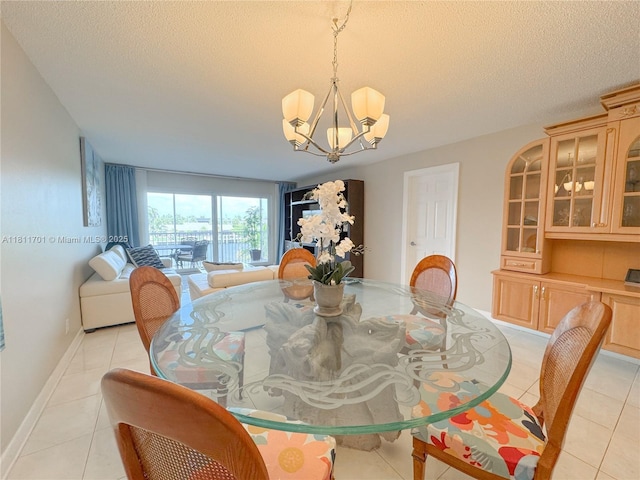 2097 S Ocean Dr Unit 302, Hallandale Beach, FL 33009 - dining room featuring a chandelier, light tile patterned flooring, and a textured ceiling