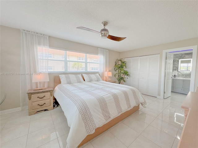 2097 S Ocean Dr Unit 302, Hallandale Beach, FL 33009 - bedroom with a closet, light tile patterned floors, baseboards, a ceiling fan, and a textured ceiling