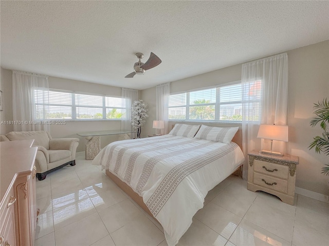 2097 S Ocean Dr Unit 302, Hallandale Beach, FL 33009 - bedroom featuring a textured ceiling, light tile patterned floors, baseboards, and ceiling fan