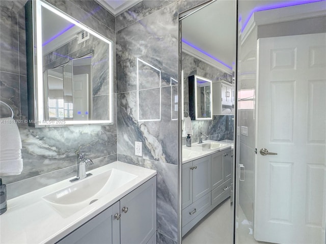2097 S Ocean Dr Unit 302, Hallandale Beach, FL 33009 - bathroom featuring tile walls, vanity, and tasteful backsplash