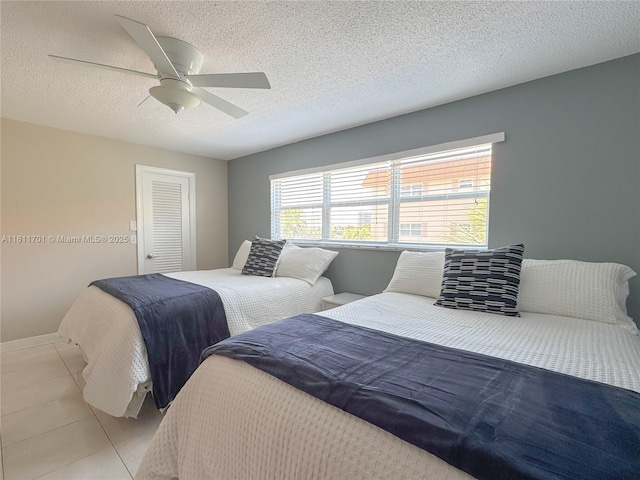 2097 S Ocean Dr Unit 302, Hallandale Beach, FL 33009 - bedroom featuring light tile patterned flooring, ceiling fan, a textured ceiling, and a closet