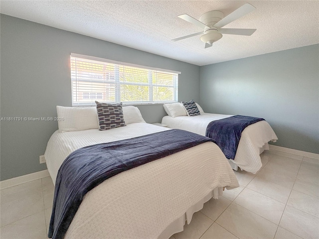 2097 S Ocean Dr Unit 302, Hallandale Beach, FL 33009 - bedroom featuring baseboards, a ceiling fan, light tile patterned floors, and a textured ceiling
