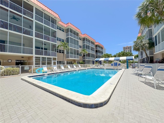 2097 S Ocean Dr Unit 302, Hallandale Beach, FL 33009 - community pool with a ceiling fan and a patio area