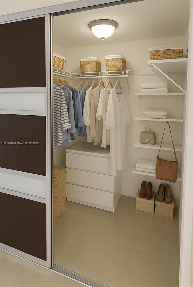 3660 NE 166th St Unit 115, North Miami Beach, FL 33160 - walk in closet featuring tile patterned floors