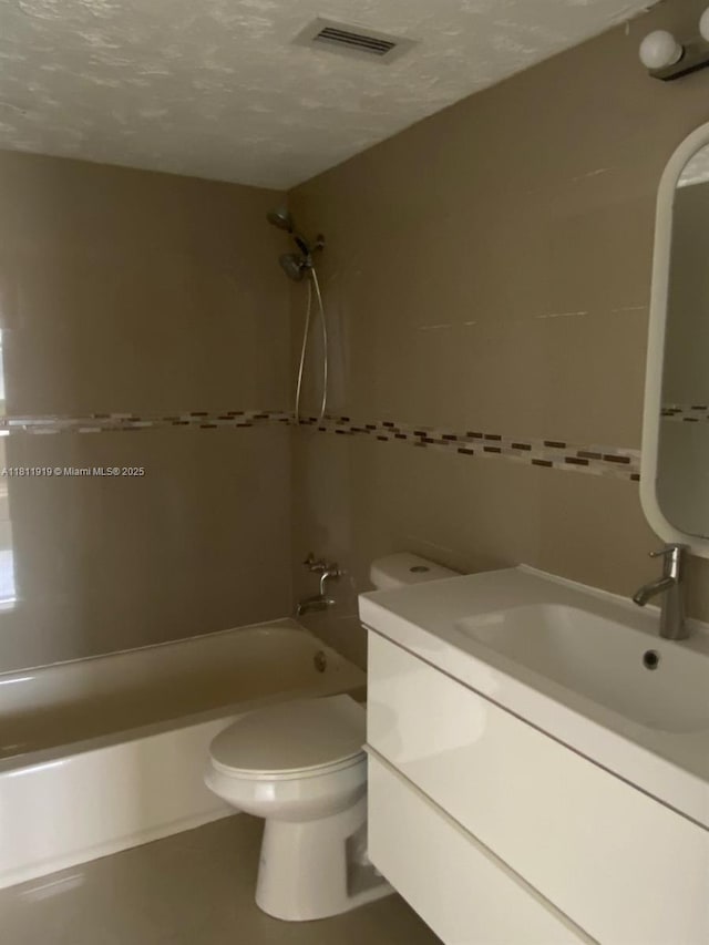 3660 NE 166th St Unit 115, North Miami Beach, FL 33160 - bathroom featuring vanity, shower / bath combination, toilet, a textured ceiling, and tile walls