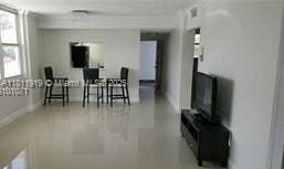 3660 NE 166th St Unit 115, North Miami Beach, FL 33160 - living room with baseboards