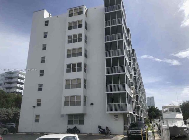 3660 NE 166th St Unit 115, North Miami Beach, FL 33160 - view of apartment building / complex featuring uncovered parking