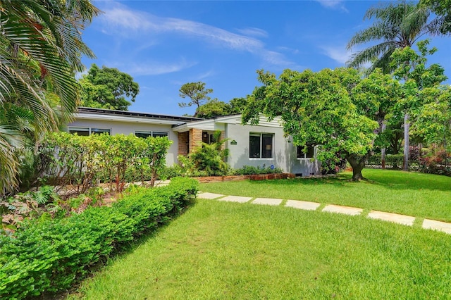 5620 Alhambra Cir, Coral Gables, FL 33146 - view of front of house featuring stucco siding and a front yard