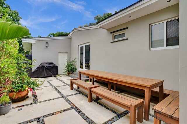 5620 Alhambra Cir, Coral Gables, FL 33146 - view of patio featuring french doors