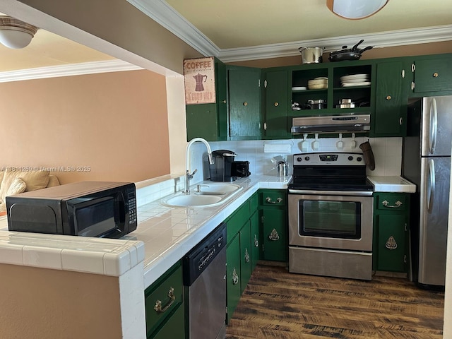 4000 NE 169th St Unit 405, North Miami Beach, FL 33160 - kitchen featuring appliances with stainless steel finishes, green cabinetry, a sink, exhaust hood, and tile counters