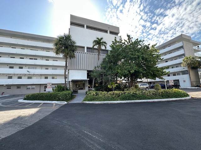 4000 NE 169th St Unit 405, North Miami Beach, FL 33160 - view of property featuring uncovered parking
