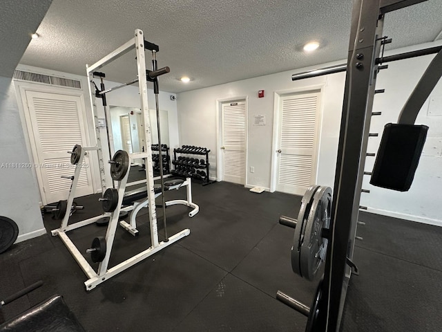 4000 NE 169th St Unit 405, North Miami Beach, FL 33160 - gym featuring a textured ceiling and baseboards