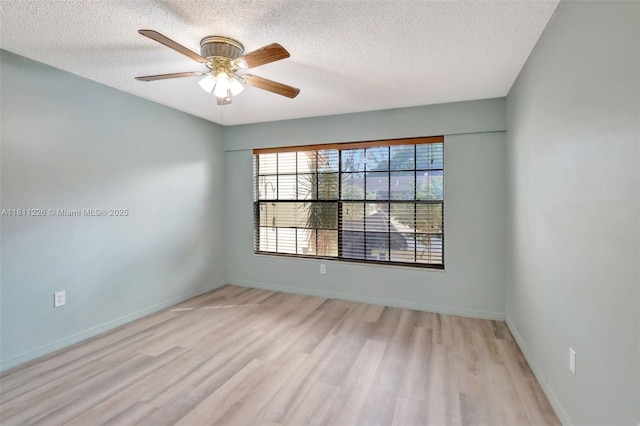 2001 Seagrape Ave, Pembroke Pines, FL 33026 - unfurnished room with a textured ceiling, wood finished floors, a ceiling fan, and baseboards
