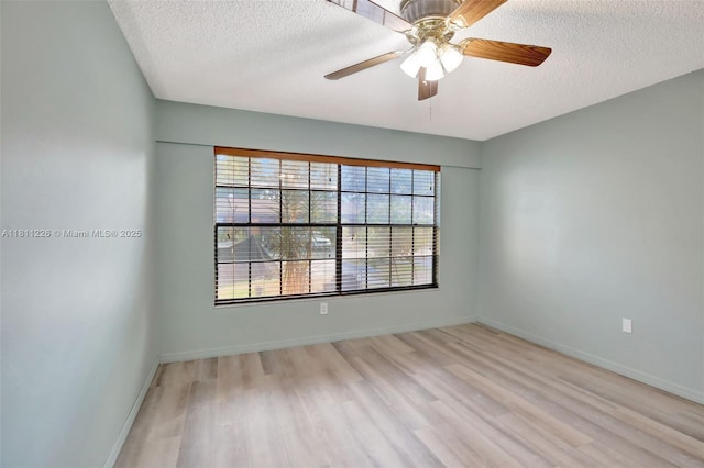 2001 Seagrape Ave, Pembroke Pines, FL 33026 - unfurnished room featuring a textured ceiling, wood finished floors, a ceiling fan, and baseboards