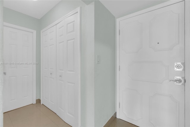 17101 NW 57th Ave Unit 110, Miami Gardens, FL 33055 - hallway featuring light tile patterned floors and baseboards