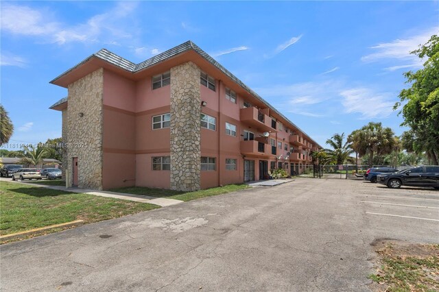 17101 NW 57th Ave Unit 110, Miami Gardens, FL 33055 - view of building exterior with uncovered parking