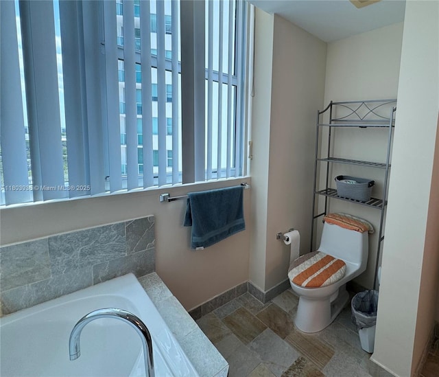 2641 N Flamingo Rd Unit 1001N, Sunrise, FL 33323 - bathroom featuring plenty of natural light, stone finish floors, toilet, and baseboards