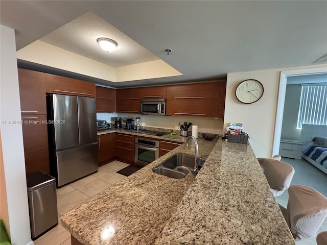 2641 N Flamingo Rd Unit 1001N, Sunrise, FL 33323 - kitchen with stainless steel appliances, a sink, a peninsula, modern cabinets, and light tile patterned floors