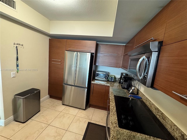 2641 N Flamingo Rd Unit 1001N, Sunrise, FL 33323 - kitchen with stainless steel appliances, light tile patterned floors, modern cabinets, and baseboards