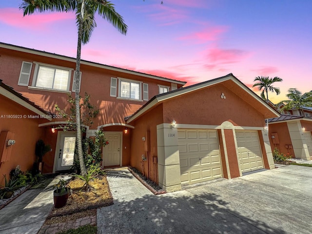 1104 NW 100th Ave, Pembroke Pines, FL 33024 - townhome / multi-family property with stucco siding, a garage, and driveway