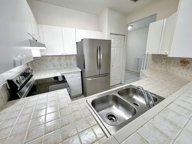 1104 NW 100th Ave, Pembroke Pines, FL 33024 - kitchen with stainless steel appliances, a sink, decorative backsplash, tile counters, and white cabinets