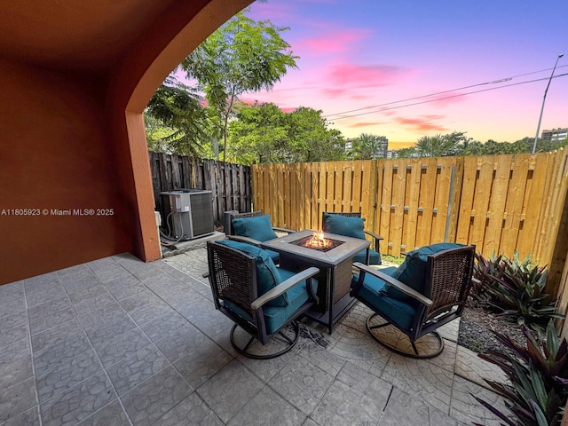 1104 NW 100th Ave, Pembroke Pines, FL 33024 - patio terrace at dusk with cooling unit, an outdoor fire pit, a patio, and a fenced backyard