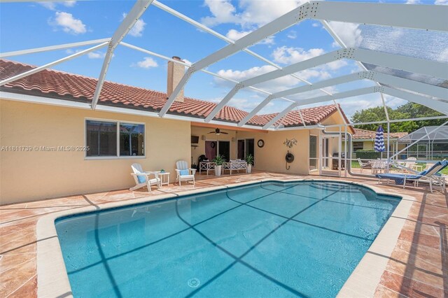 9703 NW 20th St, Coral Springs, FL 33071 - outdoor pool with a patio, ceiling fan, and glass enclosure