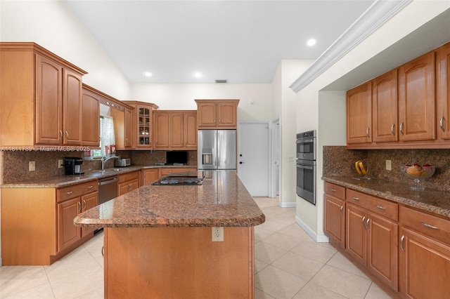 9703 NW 20th St, Coral Springs, FL 33071 - kitchen featuring stainless steel fridge, double wall oven, light tile patterned flooring, dark stone counters, and a center island