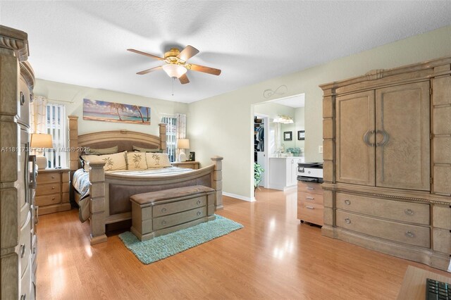 9703 NW 20th St, Coral Springs, FL 33071 - bedroom with a spacious closet, light wood-type flooring, a closet, a ceiling fan, and a textured ceiling