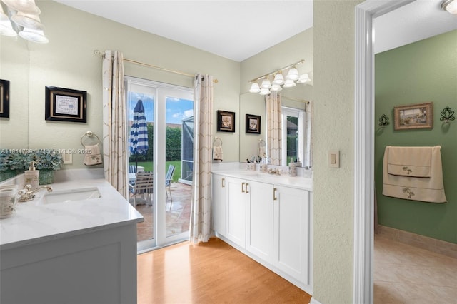 9703 NW 20th St, Coral Springs, FL 33071 - bathroom featuring vanity, a textured wall, and wood finished floors