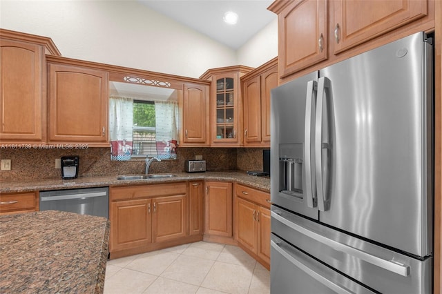 9703 NW 20th St, Coral Springs, FL 33071 - kitchen featuring appliances with stainless steel finishes, tasteful backsplash, light tile patterned floors, glass insert cabinets, and dark stone countertops