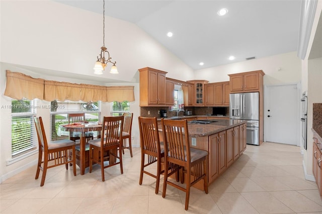 9703 NW 20th St, Coral Springs, FL 33071 - kitchen with appliances with stainless steel finishes, glass insert cabinets, tasteful backsplash, a chandelier, and a kitchen island