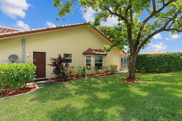 9703 NW 20th St, Coral Springs, FL 33071 - back of house with stucco siding, a yard, and a tile roof