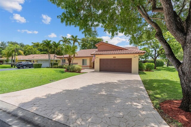 9703 NW 20th St, Coral Springs, FL 33071 - mediterranean / spanish house with a tile roof, a garage, stucco siding, and a front yard