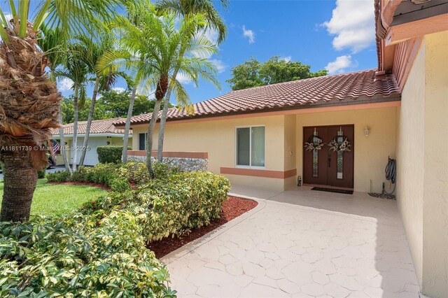 9703 NW 20th St, Coral Springs, FL 33071 - entrance to property featuring stucco siding and a tile roof