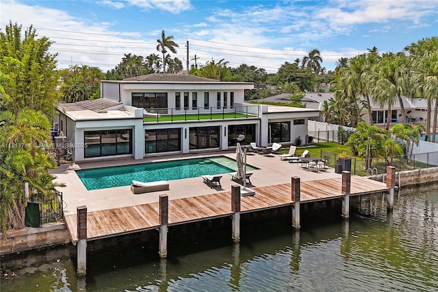 1601 Diplomat Pkwy, Hollywood, FL 33019 - back of property featuring a balcony, a patio area, an outdoor pool, stucco siding, and a water view