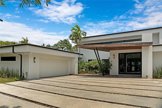 1601 Diplomat Pkwy, Hollywood, FL 33019 - exterior space featuring stucco siding, an attached garage, and concrete driveway