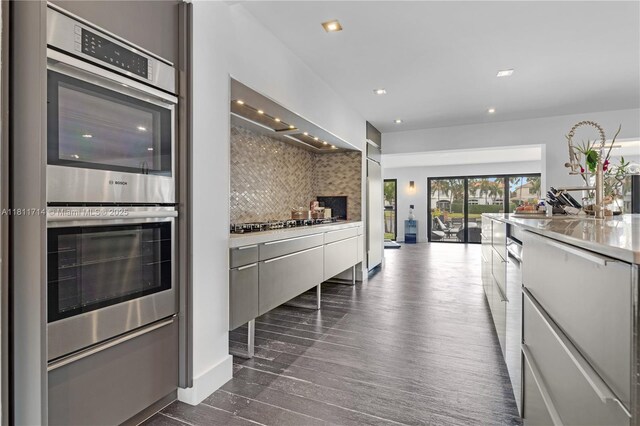 1601 Diplomat Pkwy, Hollywood, FL 33019 - kitchen with double oven, decorative backsplash, modern cabinets, gas cooktop, and recessed lighting