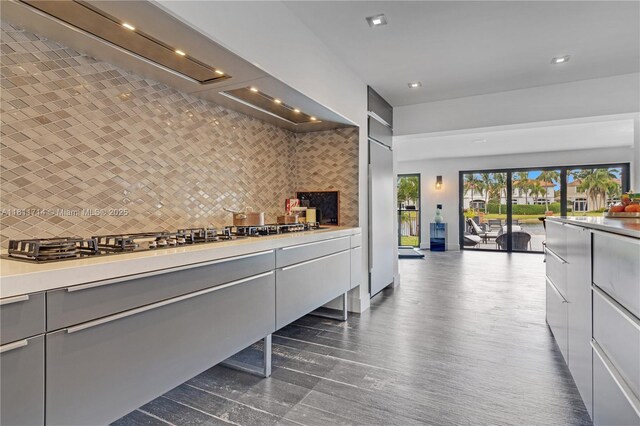 1601 Diplomat Pkwy, Hollywood, FL 33019 - kitchen with gray cabinetry, wall chimney range hood, decorative backsplash, light countertops, and recessed lighting
